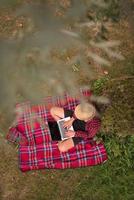 top view of man using a laptop computer under the tree photo