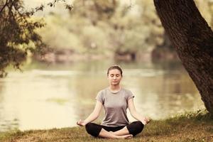 woman meditating and doing yoga exercise photo