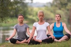women meditating and doing yoga exercise photo