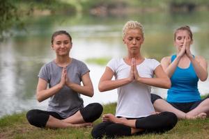 women meditating and doing yoga exercise photo