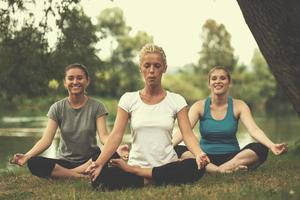 women meditating and doing yoga exercise photo