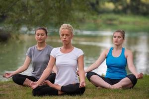women meditating and doing yoga exercise photo