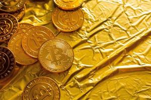 The Bitcoin cryptocurrency in gold texture  image background. photo