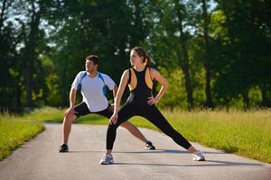 Couple doing stretching exercise  after jogging photo