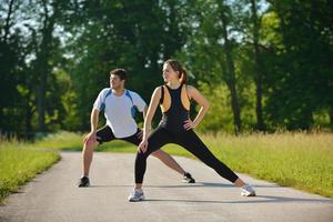 Couple doing stretching exercise  after jogging photo