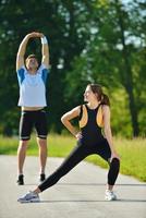 people doing stretching exercise  after jogging photo