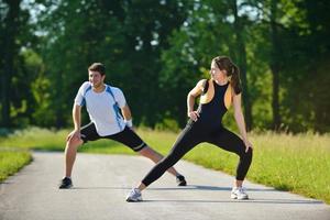 people doing stretching exercise  after jogging photo