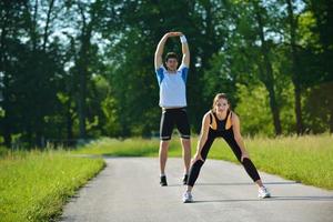 people doing stretching exercise  after jogging photo