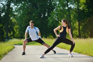 people doing stretching exercise  after jogging photo