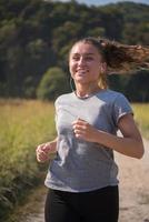 woman jogging along a country road photo