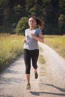 woman jogging along a country road photo