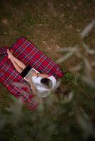 top view of man using a laptop computer under the tree photo
