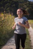 woman jogging along a country road photo