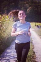 woman jogging along a country road photo
