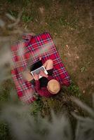top view of man using a laptop computer under the tree photo