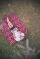 top view of man using a laptop computer under the tree photo