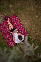 top view of man using a laptop computer under the tree photo