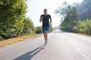 man jogging along a country road photo