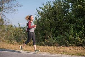 woman jogging along a country road photo