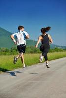 Young couple jogging at morning photo