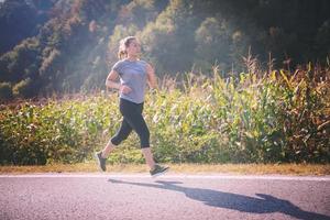 woman jogging along a country road photo