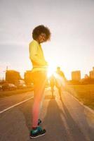 Portrait of sporty young african american woman running outdoors photo