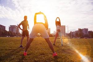 multiethnic group of people stretching in city park photo