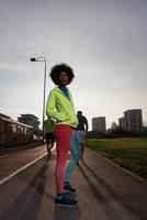 Portrait of sporty young african american woman running outdoors photo