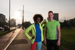 Portrait of romantic pretty couple on fitness session, outside town background photo