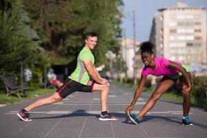 jogging couple warming up and stretching in the city photo