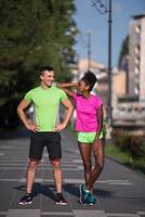 portrait of young multietnic jogging couple ready to run photo