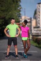 portrait of young multietnic jogging couple ready to run photo