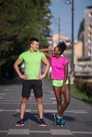 portrait of young multietnic jogging couple ready to run photo