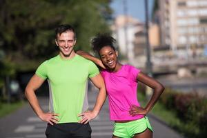 portrait of young multietnic jogging couple ready to run photo