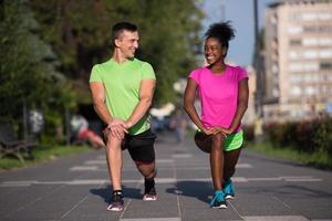 jogging couple warming up and stretching in the city photo