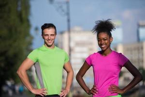 portrait of young multietnic jogging couple ready to run photo