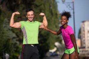 portrait of young multietnic jogging couple ready to run photo