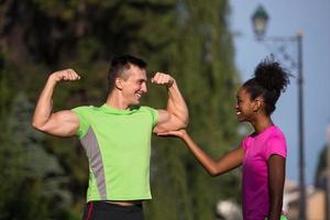 portrait of young multietnic jogging couple ready to run photo