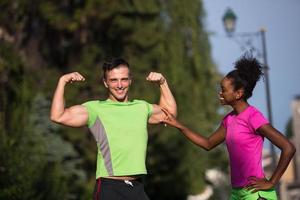 portrait of young multietnic jogging couple ready to run photo