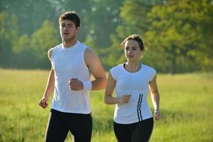 Young couple jogging at morning photo