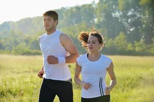 Young couple jogging at morning photo