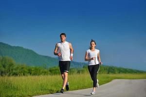 Young couple jogging at morning photo