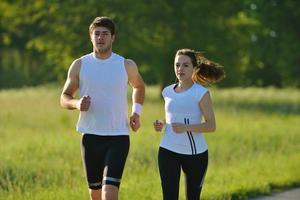 Young couple jogging at morning photo