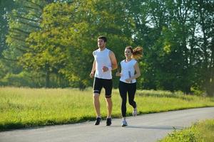 Young couple jogging at morning photo