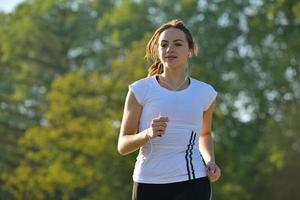 Young beautiful  woman jogging at morning in park photo