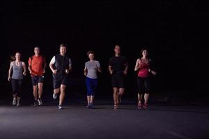 people group jogging at night photo