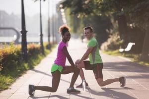 jogging couple warming up and stretching in the city photo