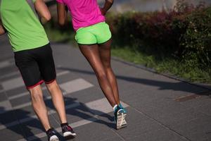 young smiling multiethnic couple jogging in the city photo