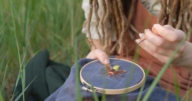 Close up of woman made hand embroidery of firefly photo