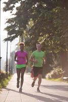 young multiethnic couple jogging in the city photo